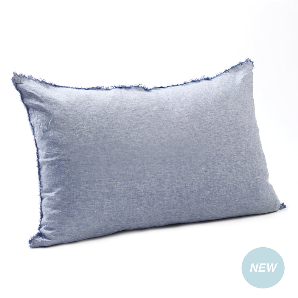 Airy chambray blue bedhead cushion in stonewashed French flax linen, with hand-tufted edges and a breezy, relaxed feel.