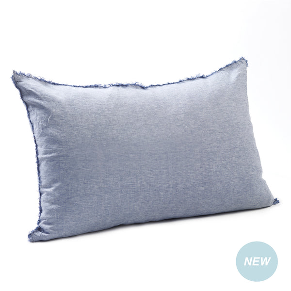 Airy chambray blue bedhead cushion in stonewashed French flax linen, with hand-tufted edges and a breezy, relaxed feel.