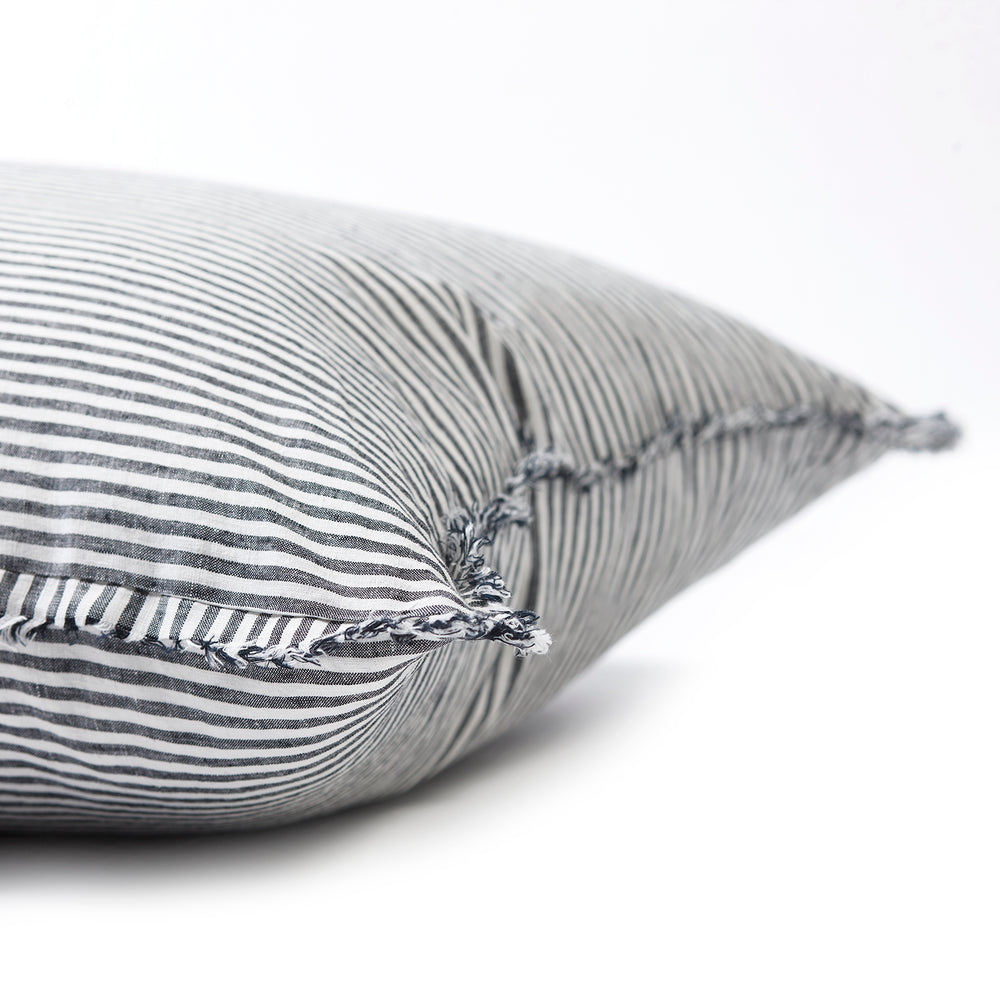 Bold dark charcoal striped bedhead cushion in stonewashed French flax linen, with hand-tufted edges, offering a sophisticated, contemporary pattern and a refined, modern touch.