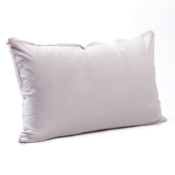 Soft lilac bedhead cushion in stonewashed French flax linen, with hand-tufted edges, offering a delicate, floral-inspired hue and a calming, elegant touch.