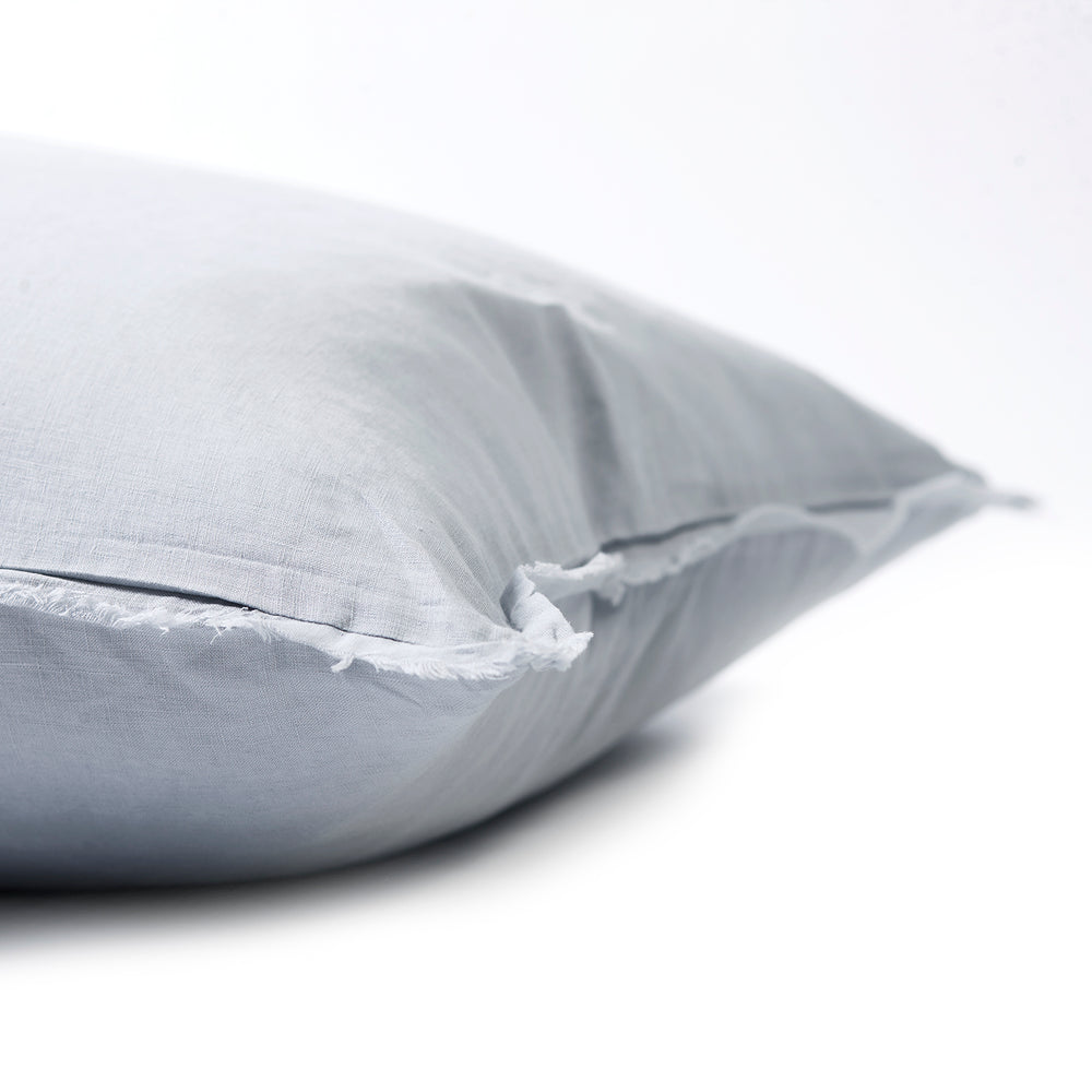 Soft mist bedhead cushion in stonewashed French flax linen, with hand-tufted edges, offering a light, airy hue that adds a serene and tranquil vibe to any space.