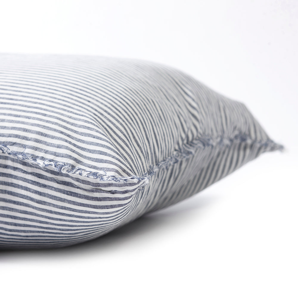 Nautical marine stripe bedhead cushion in stonewashed French flax linen, with hand-tufted edges, offering a fresh, crisp pattern that adds a coastal, sophisticated touch.