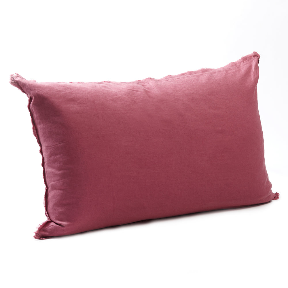 Rich raspberry bedhead cushion in stonewashed French flax linen, with hand-tufted edges, offering a vibrant pop of colour and a luxurious, contemporary feel.