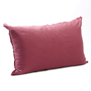 Rich raspberry bedhead cushion in stonewashed French flax linen, with hand-tufted edges, offering a vibrant pop of colour and a luxurious, contemporary feel.