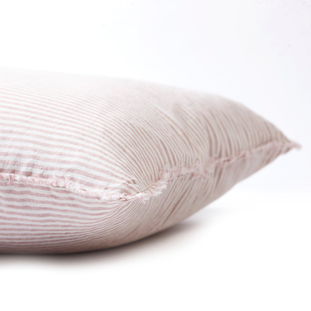 Subtle rosewater striped bedhead cushion in stonewashed French flax linen, with hand-tufted edges, bringing a soft, elegant pattern and a relaxed, feminine touch.