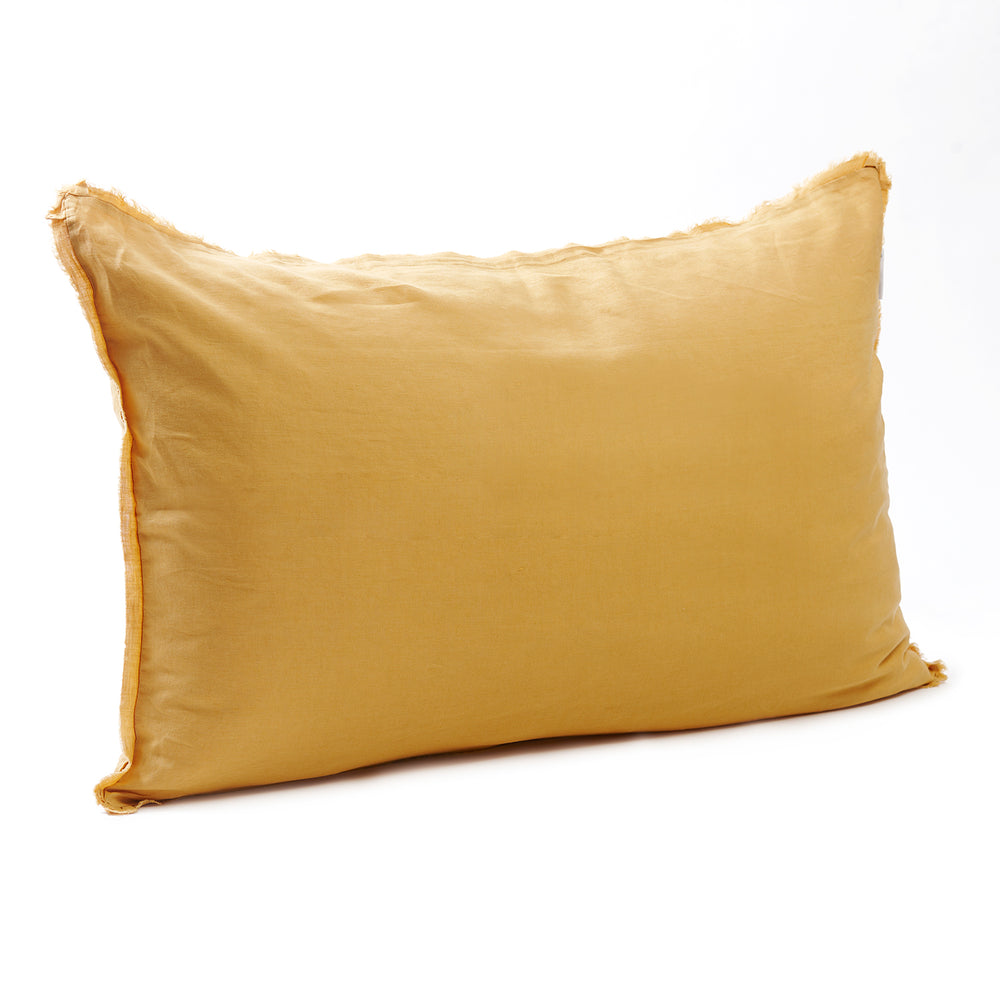 Bright sunflower yellow bedhead cushion in stonewashed French flax linen, with hand-tufted edges, bringing a cheerful, warm touch to any room.