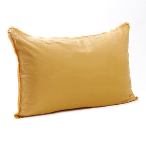 Bright sunflower yellow bedhead cushion in stonewashed French flax linen, with hand-tufted edges, bringing a cheerful, warm touch to any room.